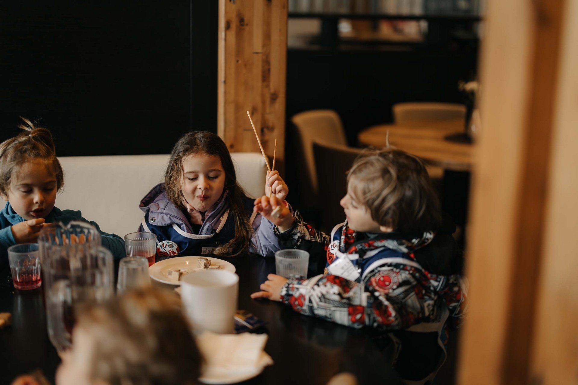 Your family resort in the Dolomites Children eating and talking together at the dining table