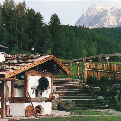 Alpine Stays for all Generations by Family Rainer Altes Holzhaus mit Holzofen und Wald vor Bergpanorama