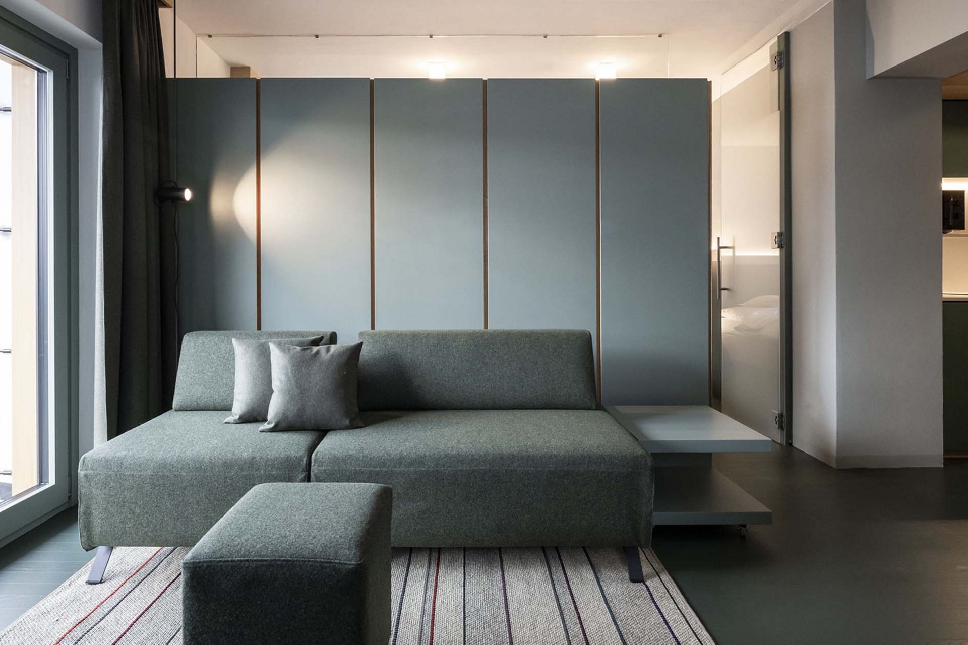 Stylish holidays at the Residence Paramount Alma Modern living room with gray sofa, two pillows, and terrace access