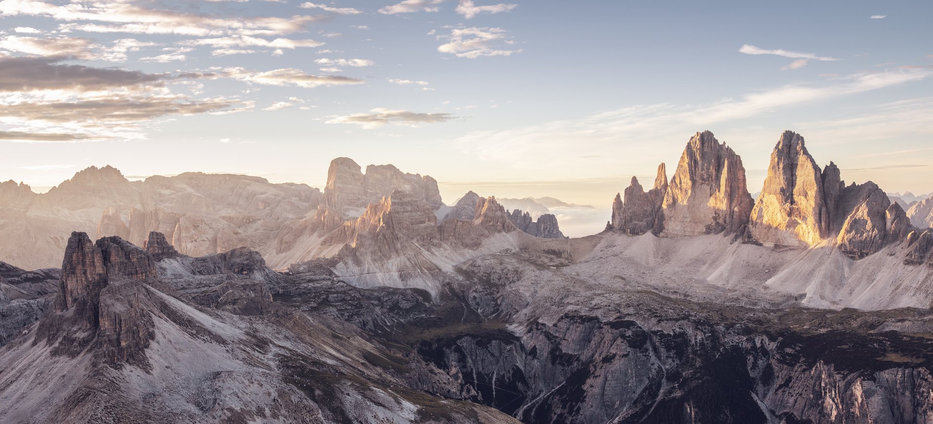 True adventure at our family hotel in the Dolomites! View of iconic Dolomite mountains at sunrise with clouds in the sky