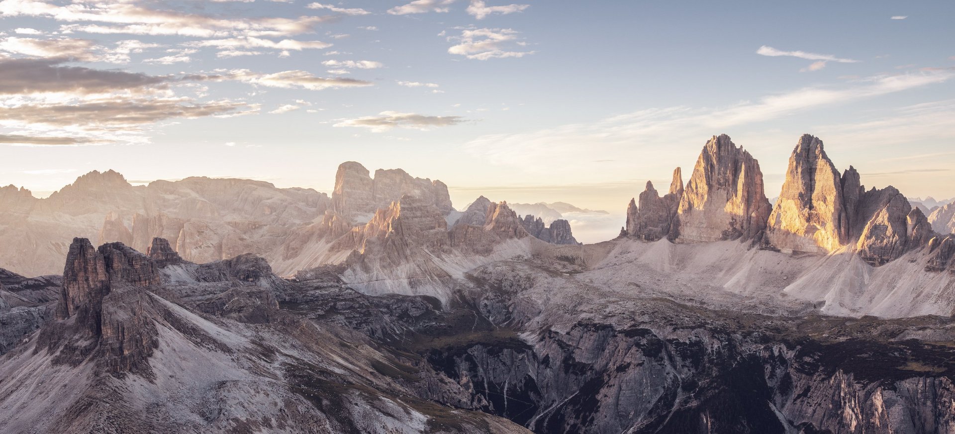 True adventure at our family hotel in the Dolomites! View of iconic Dolomite mountains at sunrise with clouds in the sky