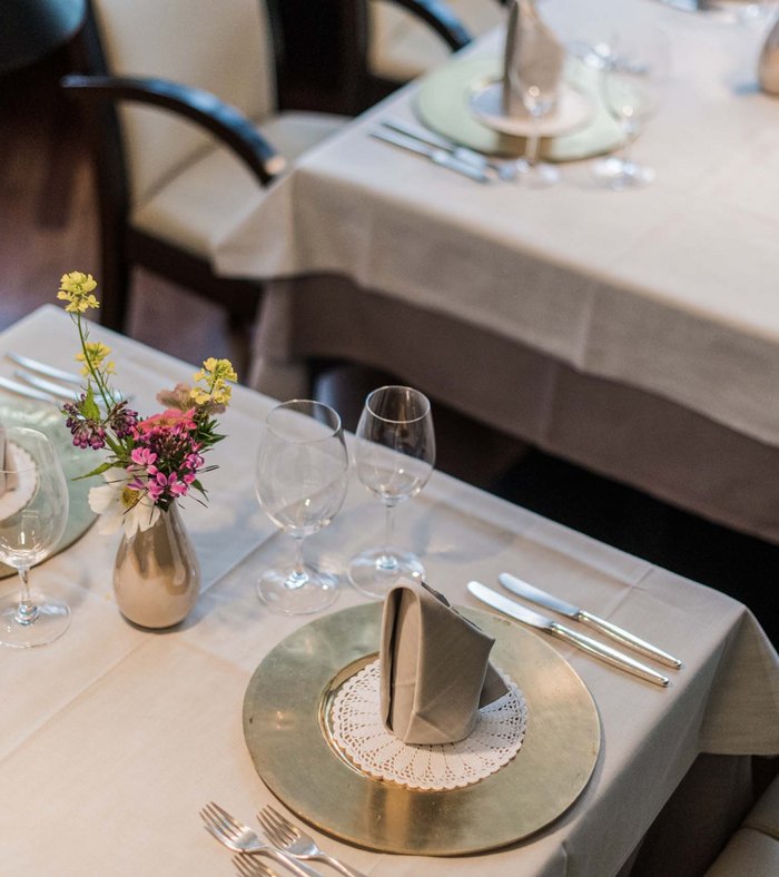 Family holidays at a gluten-free hotel Table set with elegant decorations and flowers in restaurant