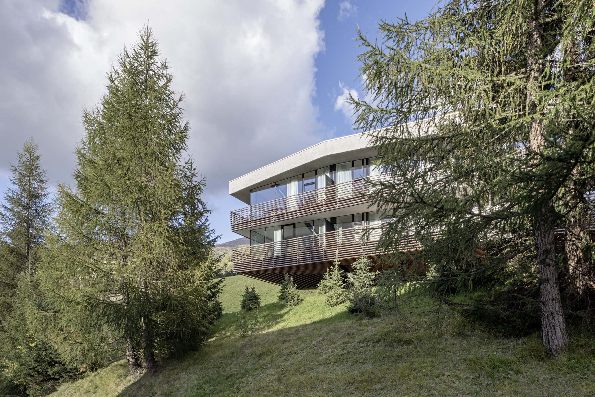 Stylish holidays at the Residence Paramount Alma Modern house with large windows on a wooded hill