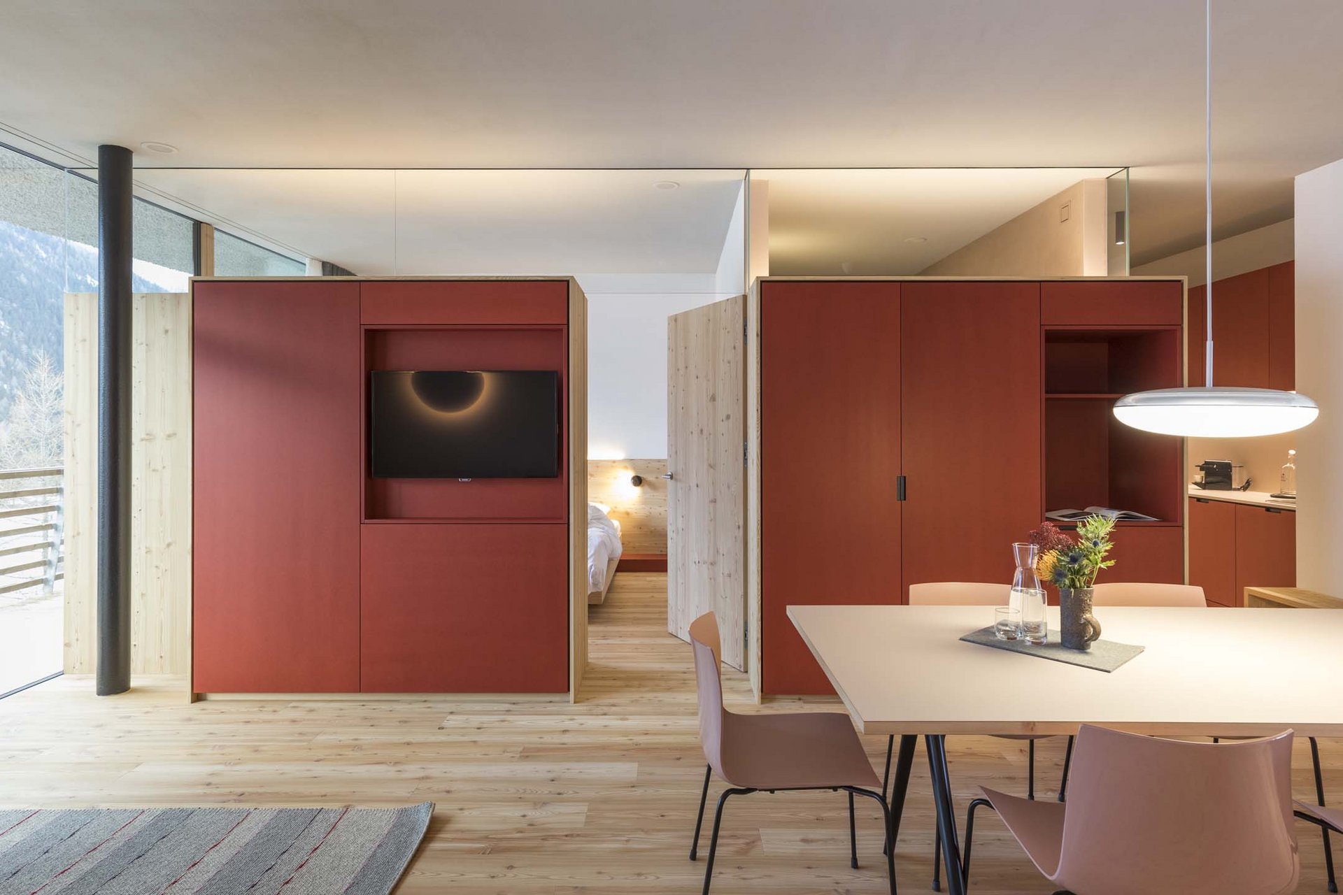 Stylish holidays at the Residence Paramount Alma Modern apartment with wooden floor, red wardrobe, and large window with mountain view