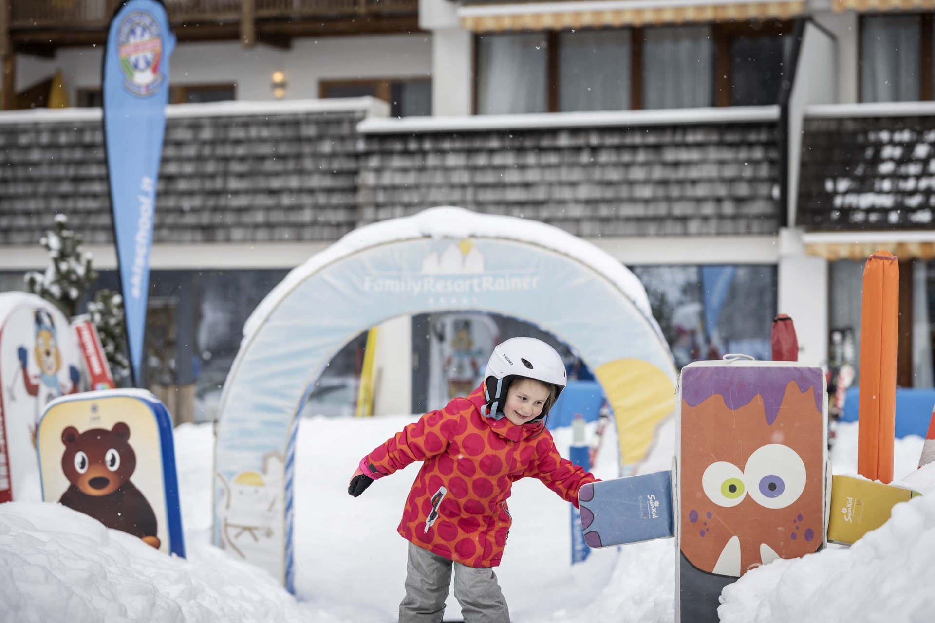 Experience exciting adventures with Raini! Child playing in snowy winter playground with colorful figures