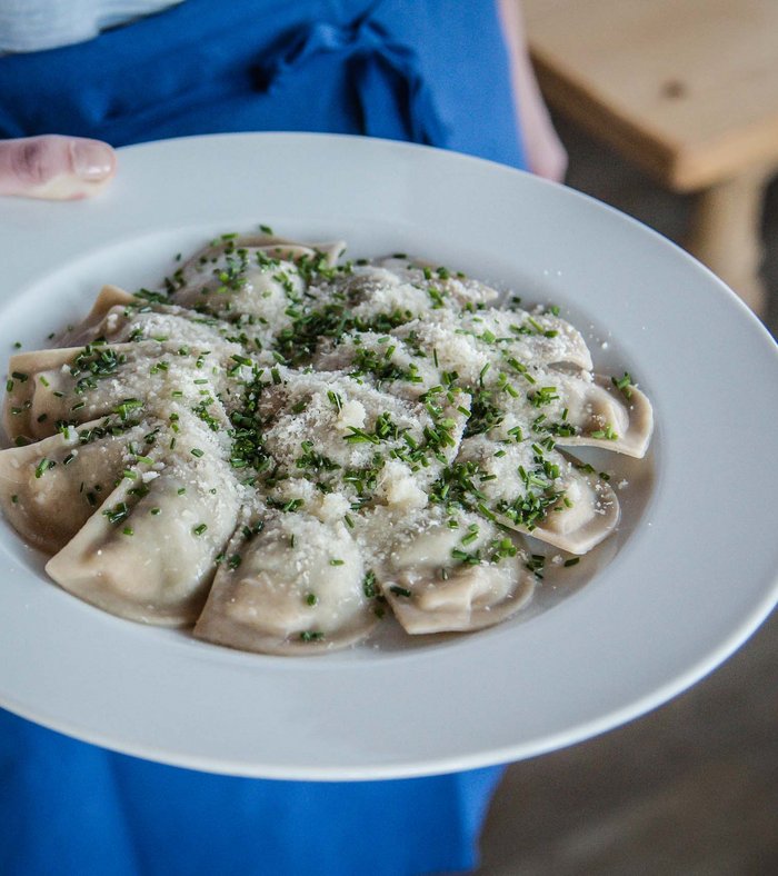 Family holidays at a gluten-free hotel Plate of ravioli topped with grated cheese and herbs