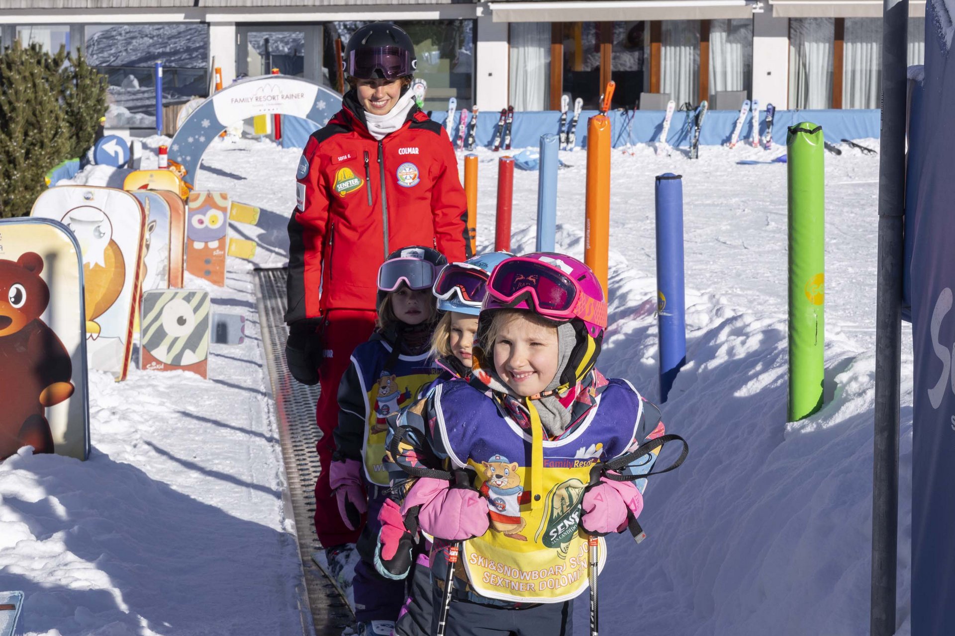 Experience exciting adventures with Raini! Children with ski gear on conveyor belt at ski resort
