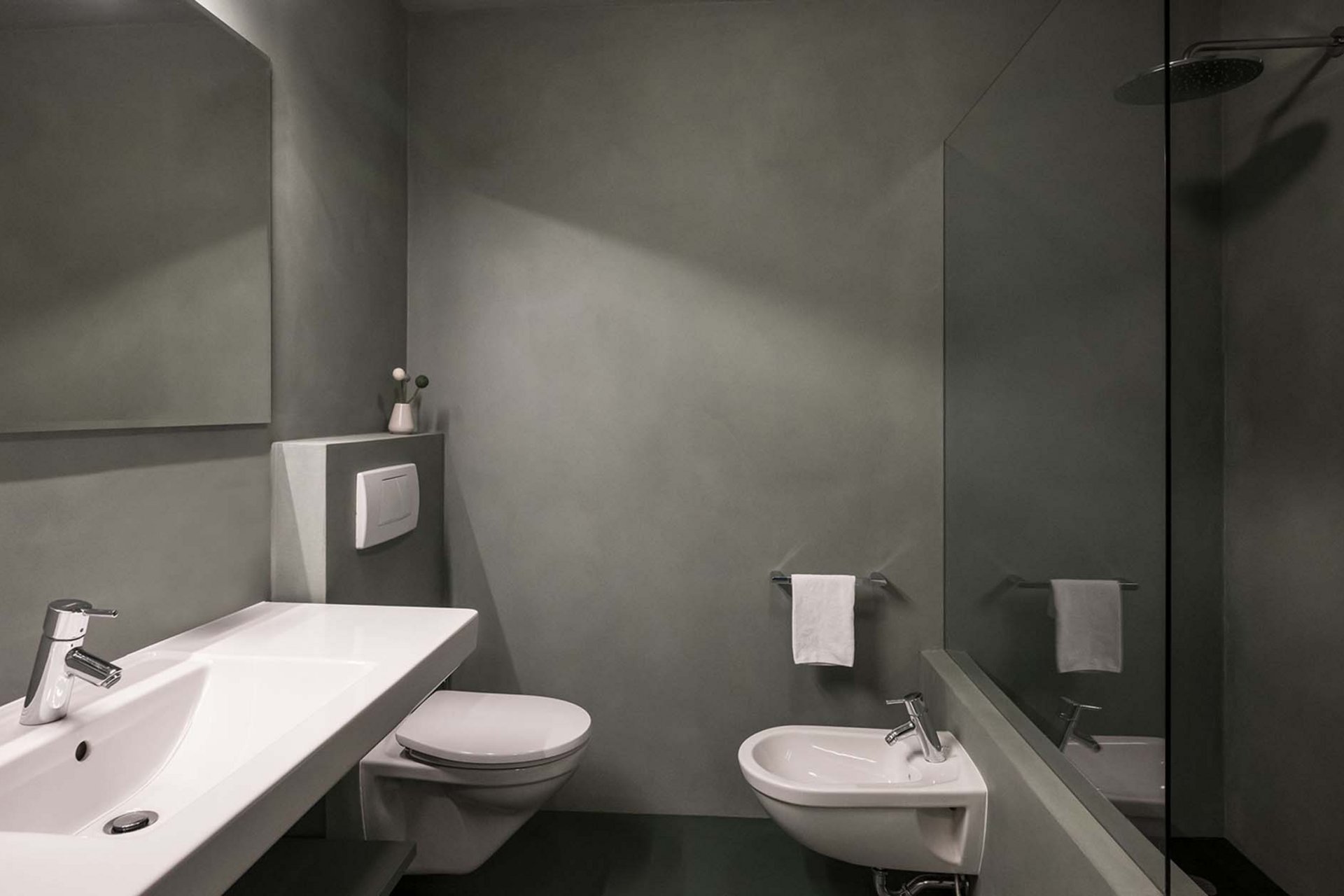 Stylish holidays at the Residence Paramount Alma Modern gray bathroom with sink, toilet, bidet, and shower