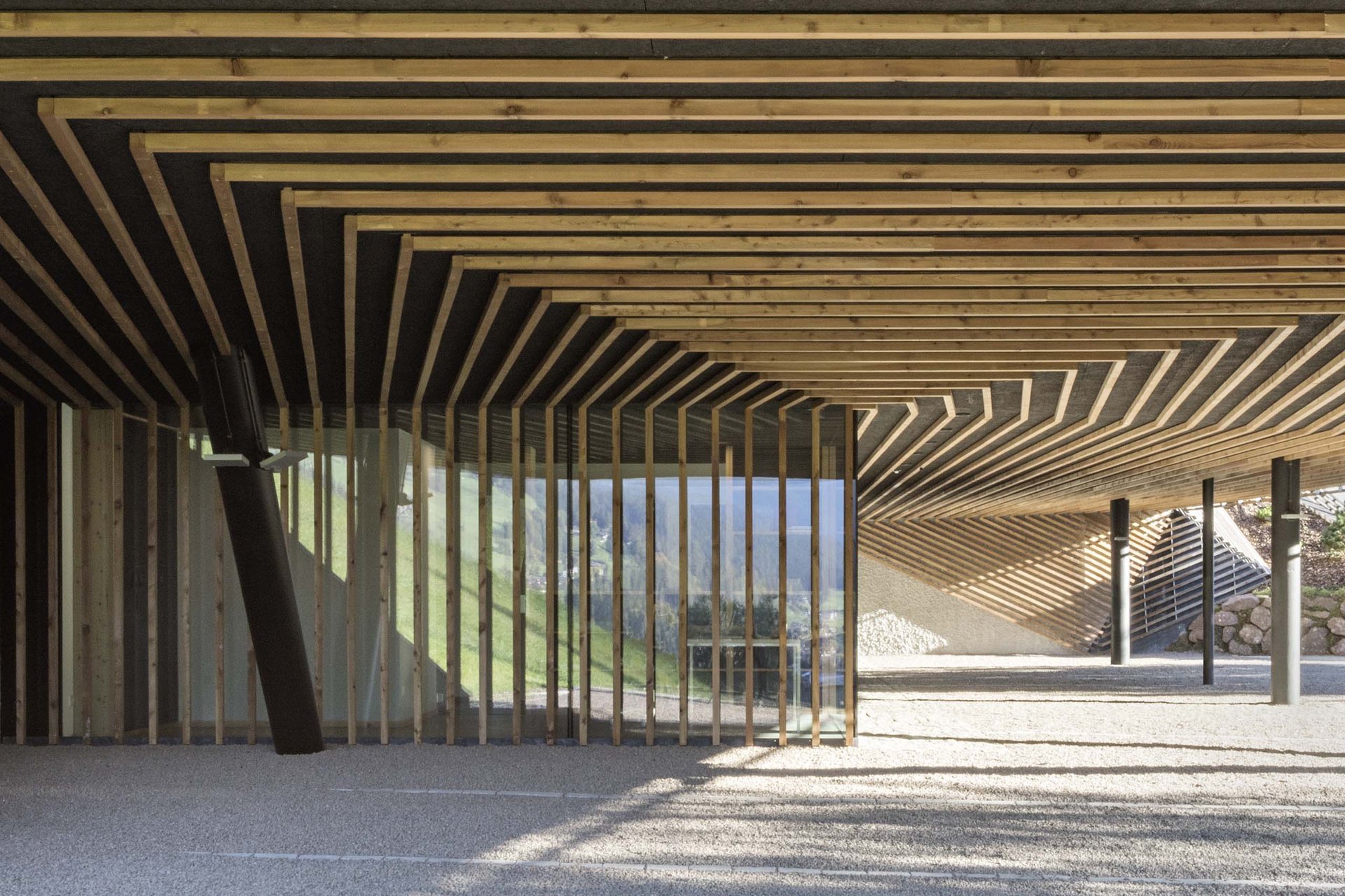 Stylish holidays at the Residence Paramount Alma Modern parking area with wooden ceiling and glass wall in minimalist design